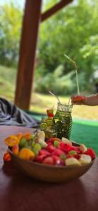 a plate of fruits and vegetables on a table at Green Idylle -Pyramid View in Visoko