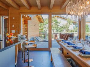 a large dining room with a long table with chairs at Chalet Woovim 8 by Interhome in Nendaz