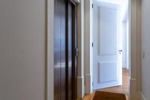 an open door in a hallway with a wooden floor at Restauradores Prime Loft in Lisbon +23 photos