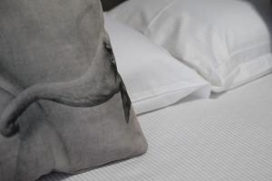 a pillow with an elephant head on a bed at Soulmade Residence in Cosenza