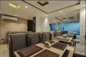 a restaurant with tables and chairs in a room at FabHotel Prime Supreme Grande - 600M From Calangute Beach in Calangute +46 photos