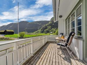 a deck with a chair and a table on a house at Holiday Home Olavbu by Interhome in Åseral