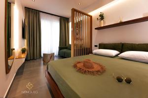 a bedroom with a bed with a hat on it at Nemausa Luxury Living in Kallithea Halkidikis +18 photos