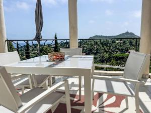 a white dining table and chairs on a balcony at Apartment L'Esquinade - FH205 by Interhome in Agay - Saint Raphael