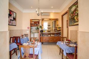 a dining room with two tables and a kitchen at Hotel Caravaggio in Rome