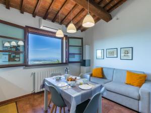 a living room with a table and a couch at Apartment Sughera by Interhome in Podere Dottrina