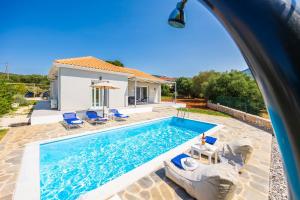 a villa with a swimming pool and a house at Villa Tania Dio in Karavádhos