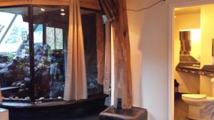 a bathroom with a fish tank in a window at Aloha Crater Lodge in Volcano