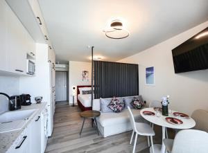 a living room with a couch and a table at Ionian Pearl Studio in Nikiana