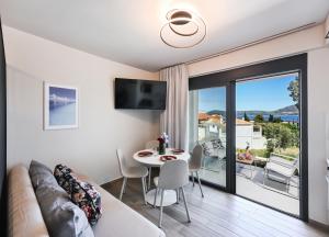 a living room with a couch and a table at Ionian Pearl Studio in Nikiana