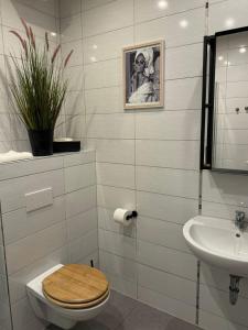 a bathroom with a toilet and a sink at Pension Kastanie in Sehlen