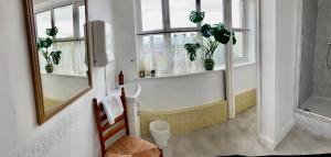 a bathroom with a sink and a window with potted plants at Room with Newly Renovated Private Bathroom above Village Pub Stag Inn Crosby Maryport in Maryport