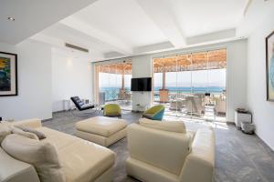 a living room with white furniture and a view of the ocean at VESTA - Soma Bay Residence in Hurghada