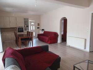 a living room with a red couch and a table at Ανετο 2 in Artemida +13 photos