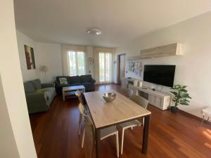 a living room with a table and a couch at Luca's Home in Villongo SantʼAlessandro