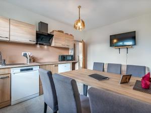 a kitchen and dining room with a table and chairs at Apartment Villa Therese by Interhome in Moosburg