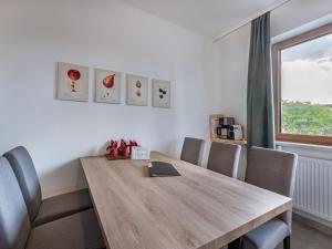 a room with a wooden table with chairs and a window at Apartment Villa Therese by Interhome in Moosburg +39 photos