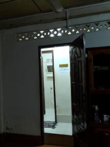 a mirror in a room with a kitchen and a refrigerator at Sakhone guesthouse in Ban Pho Touane