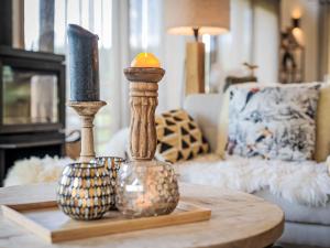 a coffee table with two vases on top of it at Chalet La Luna by Interhome in Ovronnaz +46 photos