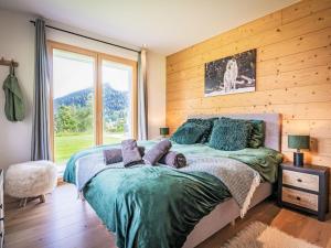 a bedroom with a bed with two people laying on it at Chalet La Luna by Interhome in Ovronnaz