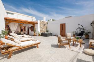 a patio with a bunch of chairs and tables at La casa di Fina in Archangelos