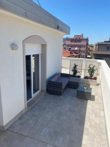 a balcony of a white building with a patio at Rimini Bay Suites&Residence in Rimini