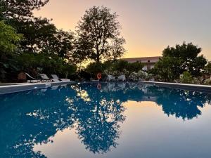 a swimming pool with a reflection in the water at La Casetta Colonica in Cefalù