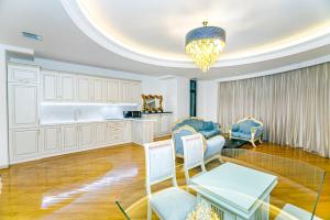 a living room with white cabinets and a chandelier at Marina Luxury Apartment in Nizami st in Baku