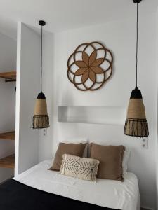 a bedroom with two pendant lights above a bed at Apartamento Café Bernal in Tarifa
