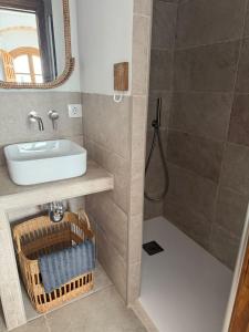 a bathroom with a sink and a shower at Apartamento Café Bernal in Tarifa +19 photos