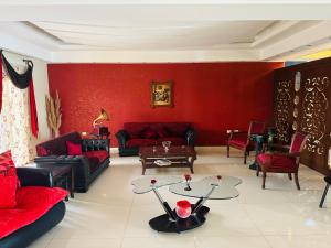 a living room with red walls and red furniture at Reef Zefta Hotel in Zefta