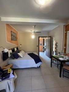 a bedroom with a bed and a table in it at Guest House Elisabeth in Pinerolo