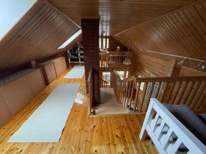 an attic room with wooden floors and a staircase at Villa Kortepuro  +20 photos
