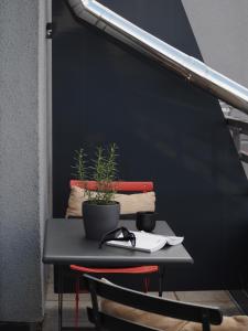 a black table with a plant on top of it at Bold Hotel München Giesing in Munich