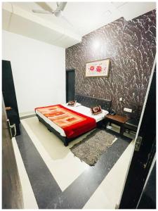 a bedroom with a bed and a table in it at Amritsar Hotel R-A-M-N-E-E-K Near Bus Stand - Spacious Rooms With Free Wi-fi - Restaurant# Parking & Excellent Customer Service - Best Location In Amritsar in Amritsar