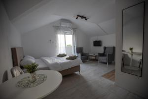 a bedroom with a bed and a table in a room at Apartmani Trio in Trebinje