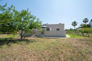 a house with a tree in a yard at Stone and Sea Kos Oasis in Kos Town