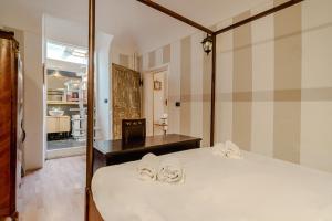 a bedroom with a bed with two slippers on it at Piazza Vittorio Veneto Elegant Flat in Turin