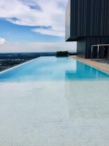 a swimming pool on top of a building at Great facilities n River view n Local in Ban Sai Ma