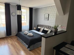 Posteľ alebo postele v izbe v ubytovaní H-T-L Apartamenty Junior