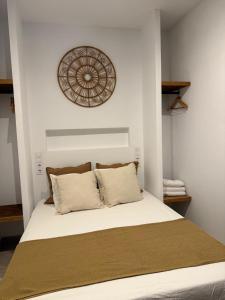 a bedroom with a large bed with white sheets at Estudio 1 Café Bernal in Tarifa