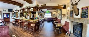 a bar in a restaurant with tables and chairs at Room with Newly Renovated Private Bathroom above Village Pub Stag Inn Crosby Maryport in Maryport +11 photos