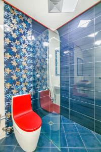 a bathroom with a red toilet sitting in a room at Marina Luxury Apartment in Nizami st in Baku +48 photos