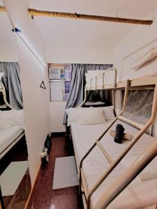 a room with two bunk beds and a kitchen at Cozy full Apartment 2 bedroom central area in Hong Kong