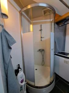 a shower with a glass door in a bathroom at Cozy full Apartment 2 bedroom central area in Hong Kong