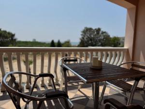 a table and chairs on a balcony with a coffee cup at Apartments Bernarda 1 in Nin