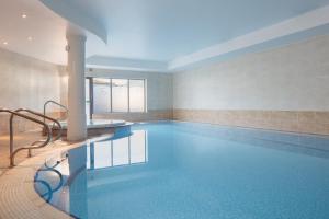 a pool in a hotel room with a swimming pool at The Worcester Whitehouse Hotel in Worcester