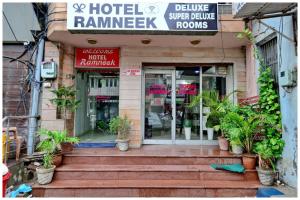 a store with potted plants in front of a building at Amritsar Hotel R-A-M-N-E-E-K Near Bus Stand - Spacious Rooms With Free Wi-fi - Restaurant# Parking & Excellent Customer Service - Best Location In Amritsar in Amritsar
