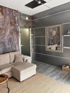 a living room with a couch and a table at Loft style big studio for 2-4 in Pikku Huopalahti in Helsinki
