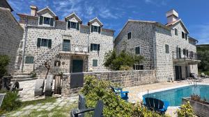 a large stone building with a swimming pool at Villa Noni in Klinci